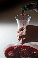 red wine being served in a decanter during tasting photo