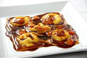 chocolate ravioli with strawberry sauce photo