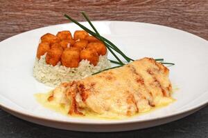 cod with cheese and rice with fried cheese cubes photo