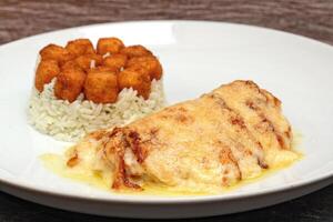 cod with cheese and rice with fried cheese cubes photo