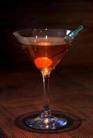 Manhattan, classic drink with bourbon whiskey, sweet vermouth, angustura and cherry photo