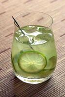Caipiroska, drink with vodka, lemon, sugar and ice in a glass photo