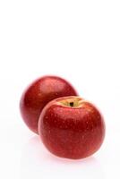 red wet Fuji apple on white background photo