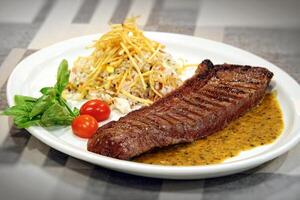 Fillet in sauce with rice and fries photo