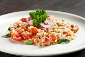 tomato risotto with onion on plate photo