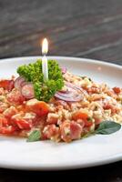 tomato risotto with onion on plate photo
