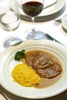 scaloppine al marsala with saffron risotto photo