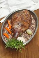 step by step guide to Gigot d'agneau, a classic dish of French cuisine, leg of lamb with pink garlic, rosemary, port wine and olive oil photo