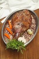 step by step guide to Gigot d'agneau, a classic dish of French cuisine, leg of lamb with pink garlic, rosemary, port wine and olive oil photo