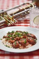 cajun food with rice, beans and seasoned sausage on plate photo