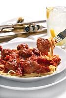 spaghetti in tomato sauce with meatballs photo