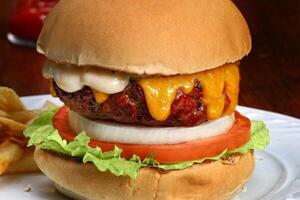 classic Brazilian cheeseburger salad with cheese, lettuce, tomato and bacon photo