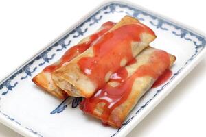 Harumaki, famous spring roll with red sweet and sour sauce photo