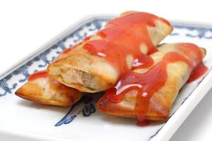 Harumaki, famous spring roll with red sweet and sour sauce photo