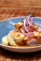 Ceviche, classic Peruvian dish with raw fish, onions, pepper and lemon juice photo