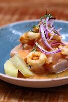 Ceviche, classic Peruvian dish with raw fish, onions, pepper and lemon juice photo