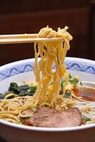 Japanese ramen, soup mix with noodles, meat, eggs and vegetables photo