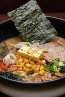 Japanese ramen, soup mix with noodles, meat, eggs and vegetables photo