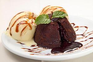 petit gateau with cream ice cream and chocolate sauce photo