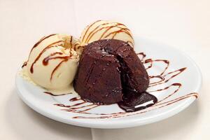 petit gateau with cream ice cream and chocolate sauce photo