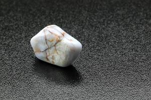 Larimar, Brazilian gemstone on dark background photo