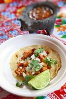 Taco al Pastor, classic Mexican cuisine with onion, paprika, chipotle, corn flour and pork loin photo