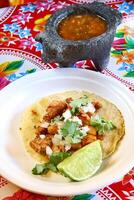 Taco al Pastor, classic Mexican cuisine with chipotle, paprika, onions and pork loin photo