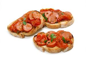 sausage bruschetta with tomato sauce on toasted bread photo