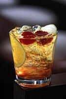 Old Fashioned, classic drink with whiskey, sparkling water, sugar, angustura and ice photo