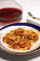 Ravioli with meat filling and tomato sauce photo