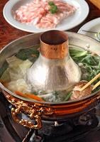 shabu shabu, typical Japanese dish with beef tenderloin, carrots, pumpkins, tofu, mushrooms, chicken broth and ponzu sauce photo