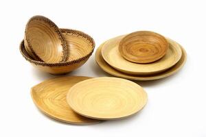 wooden cups, platters and trays on white background photo