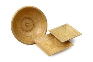 wooden cups, platters and trays on white background photo