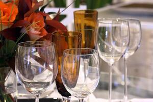 sophisticated tables with plates, cutlery and fine glasses close-up photo