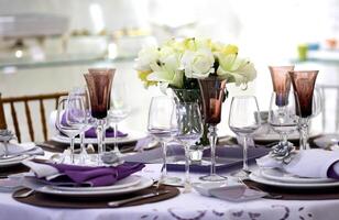 sophisticated tables with plates, cutlery and fine glasses close-up photo