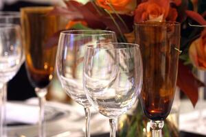 sophisticated tables with plates, cutlery and fine glasses close-up photo