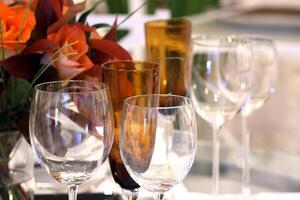 sophisticated tables with plates, cutlery and fine glasses close-up photo