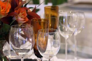 sophisticated tables with plates, cutlery and fine glasses close-up photo