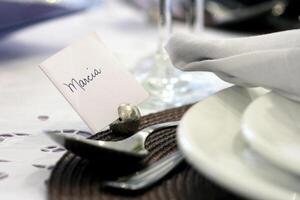 sophisticated tables with plates, cutlery and fine glasses close-up photo