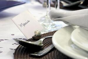 sophisticated tables with plates, cutlery and fine glasses close-up photo