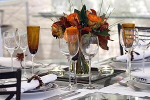 sophisticated tables with plates, cutlery and fine glasses close-up photo