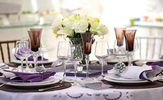 sophisticated tables with plates, cutlery and fine glasses close-up photo