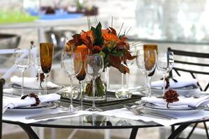 sophisticated tables with plates, cutlery and fine glasses close-up photo