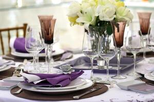 sophisticated tables with plates, cutlery and fine glasses close-up photo