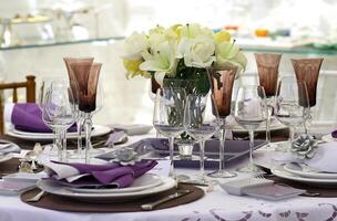 sophisticated tables with plates, cutlery and fine glasses close-up photo