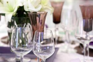sophisticated tables with plates, cutlery and fine glasses close-up photo