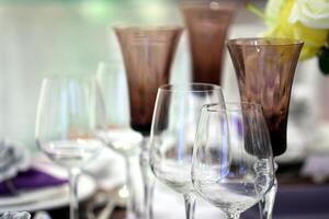 sophisticated tables with plates, cutlery and fine glasses close-up photo