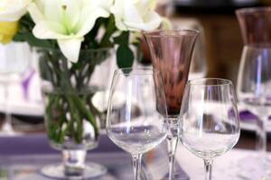 sophisticated tables with plates, cutlery and fine glasses close-up photo