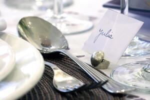 sophisticated tables with plates, cutlery and fine glasses close-up photo