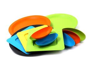 plastic and acrylic platters, plates and bowls on white background photo